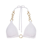 A white triangle bikini top with gold hoops against a white wall. 