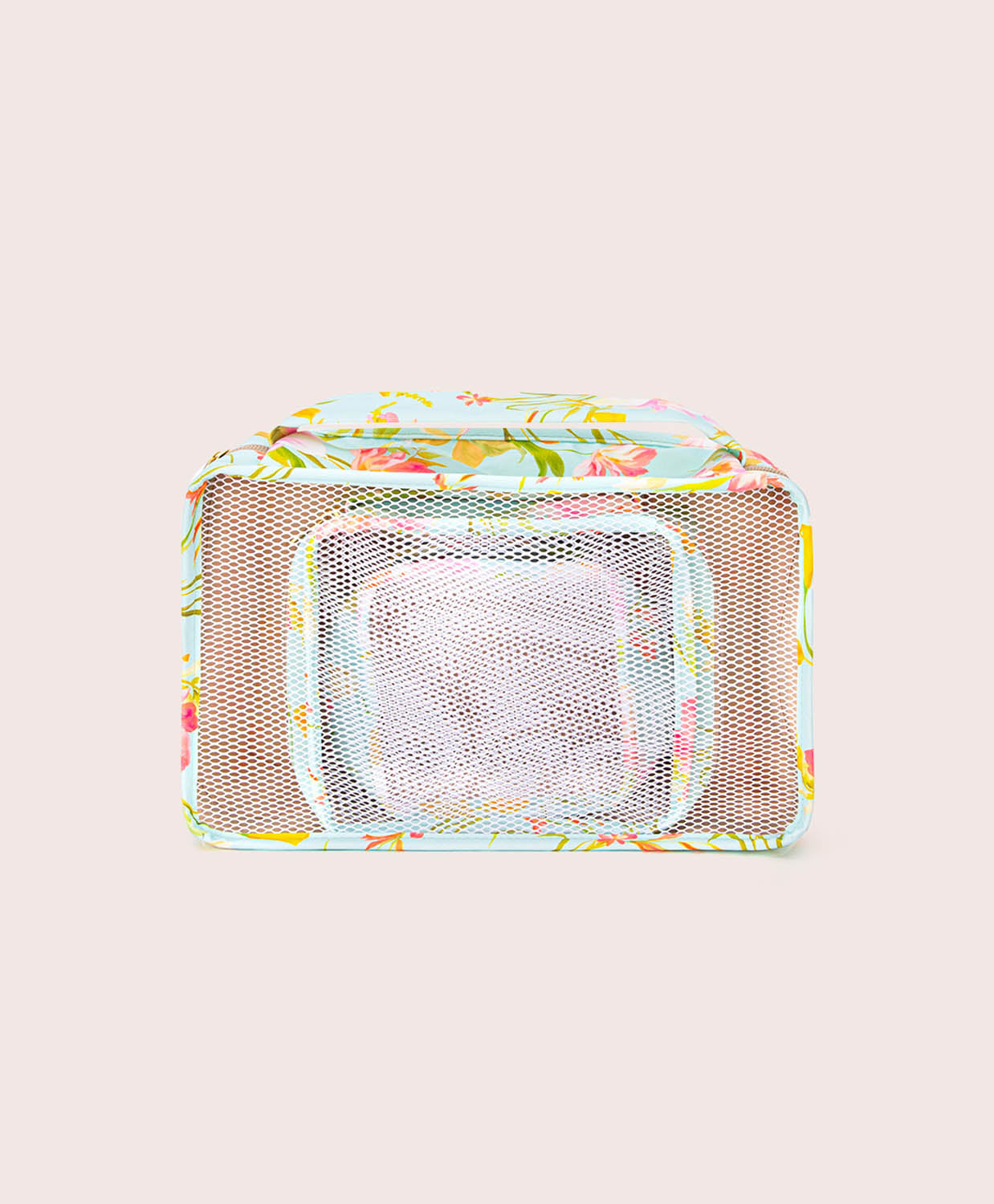 Multicolored mesh packing cube with floral pattern on a beige background