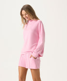 Woman wearing a pink outfit on a white background