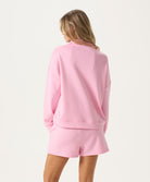 Woman wearing a pink outfit on a white background