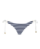 A blue and white striped tie side bikini bottom against a white wall. 