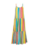 A floor length multi colored dress against a white wall. 