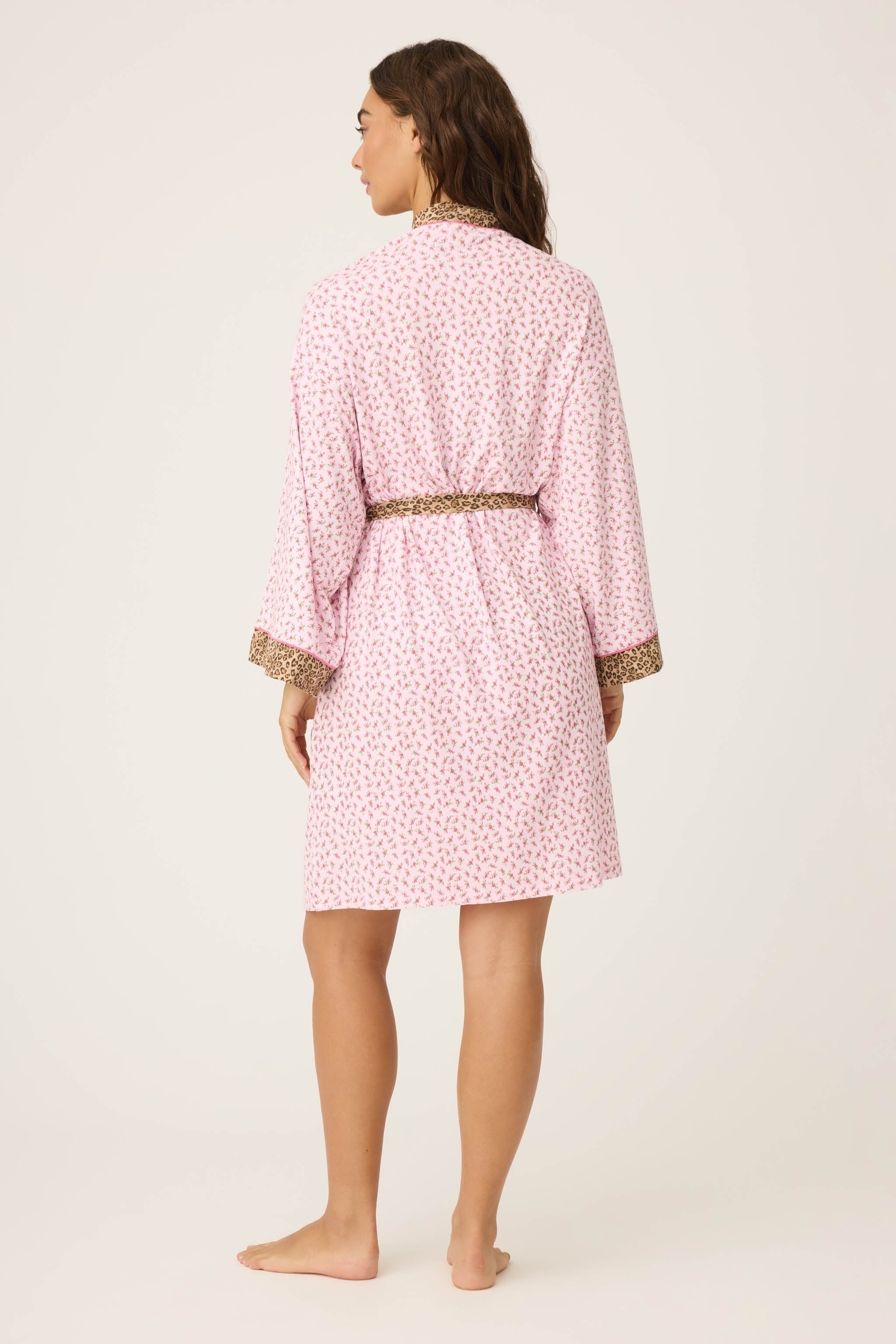 Ditsy Floral Robe featuring a pink ditsy floral print with leopard trim, wide sleeves, and a relaxed, silky-soft jersey fit.