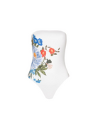 A white strapless one-piece swimsuit with a colorful floral print on the front, featuring blue, red, and pink flowers with green leaves, displayed on a white mannequin torso against a plain white background.