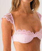 Pink lace bikini top on a plain background