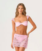 Rosé Lace Maycee Skirt mini skirt in pastel pink with hand-cut lace detailing and scalloped hem.