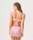 Rosé Lace Maycee Skirt mini skirt in pastel pink with hand-cut lace detailing and scalloped hem.