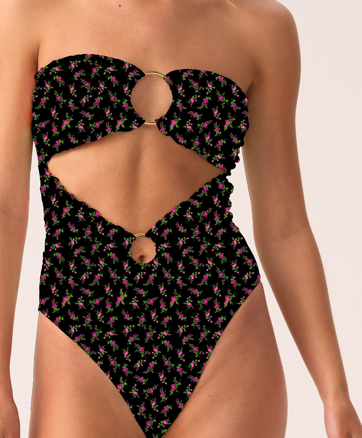Woman wearing a black patterned strapless swimsuit on a white background