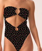 Woman wearing a black patterned strapless swimsuit on a white background