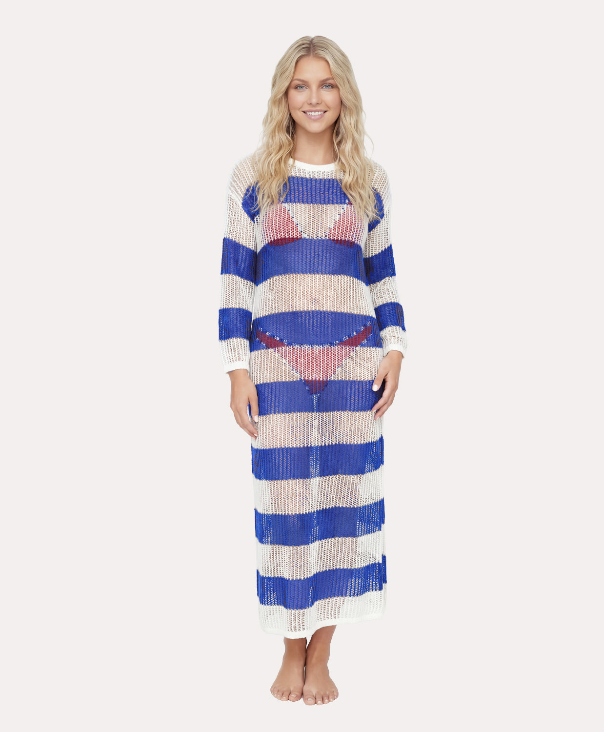 Woman wearing a long, striped dress with blue and white stripes on a plain background