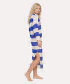 Woman wearing a blue and white striped long cardigan on a white background