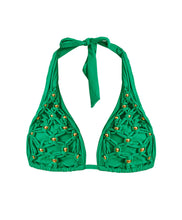A green bikini top halter style with gold beading and net macramé details. Featured against a white wall background.