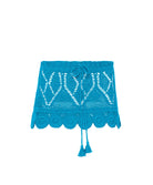 Blue crochet skirt with white patterns on a white background