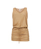 A gold short coverup dress with front tie detail. Featured against a white wall background.