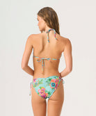 Woman wearing a colorful floral bikini on a white background