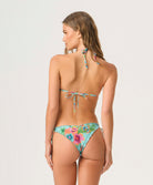 Woman wearing a colorful floral bikini on a white background