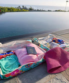 Open packing cube with beach items by a poolside