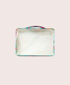 Rectangular packing cube with a colorful handle on a light pink background