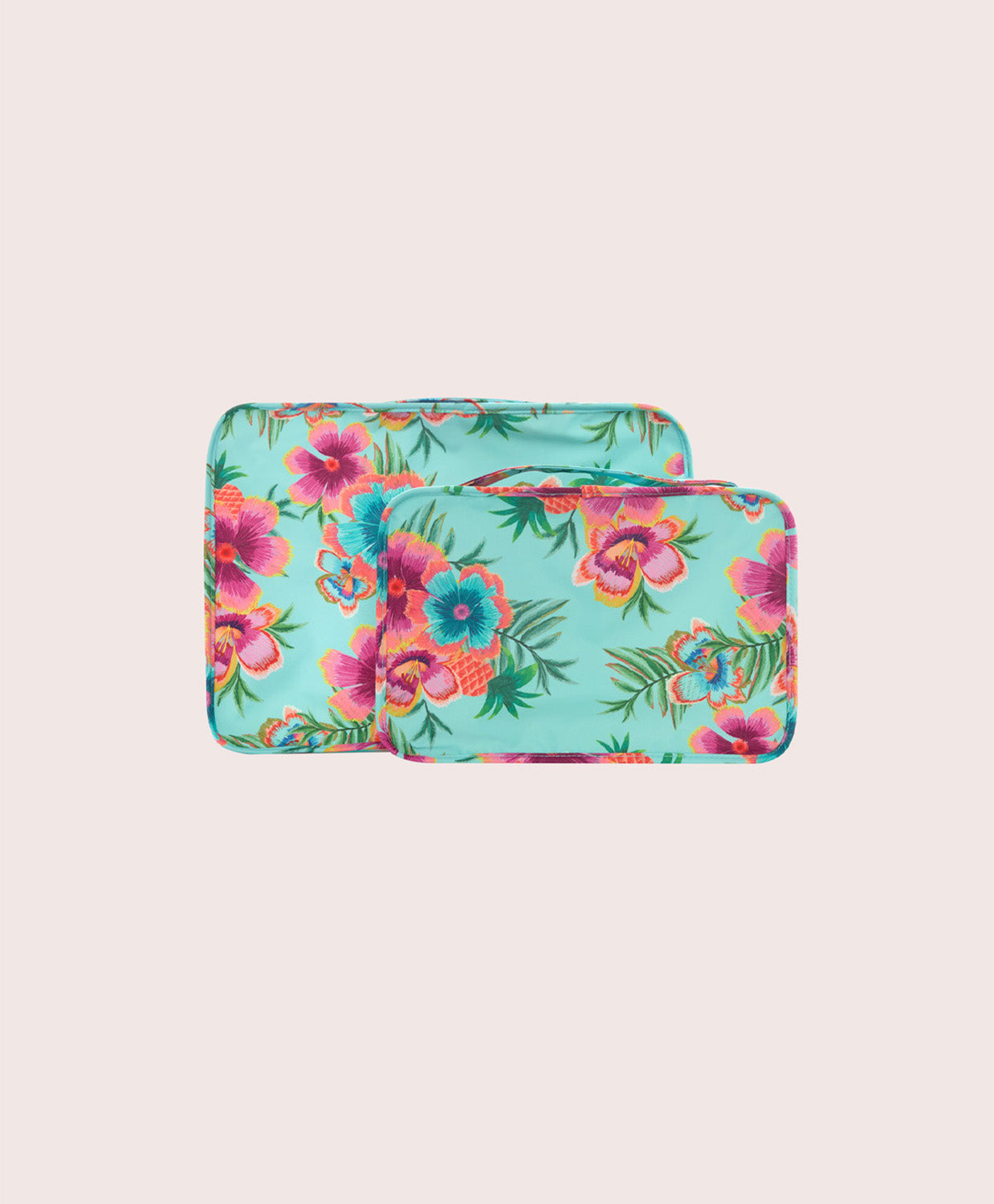 Two floral-patterned packing cubes on a light pink background