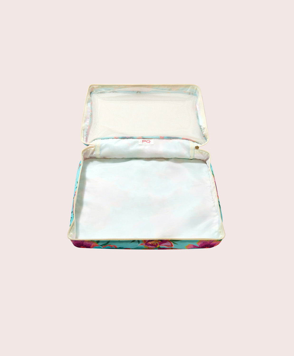 Packing cube with floral design on a light pink background