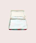 Packing cube with floral design on a light pink background