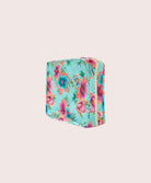 Floral-patterned packing cube on a light beige background
