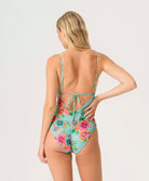 Woman wearing a floral swimsuit on a white background