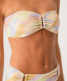 Pastel patterned bikini top on a neutral background