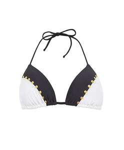 A black and white triangle bikini top with stud details. Featured against a white wall background.