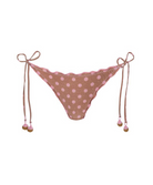 A pink and brown polka dot bikini bottom with a scalloped edge, side tie straps, and small pom-pom details, shown against a plain white background.