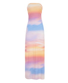 A multi colored floor length dress against a white wall. 