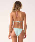Woman wearing a light blue bikini with a white background