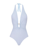 A light blue one piece swimsuit against a white wall.