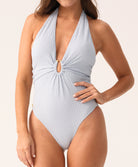 Light blue patterned halter neck swimsuit worn by a model on a plain background