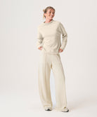 Woman wearing a beige set on a white background