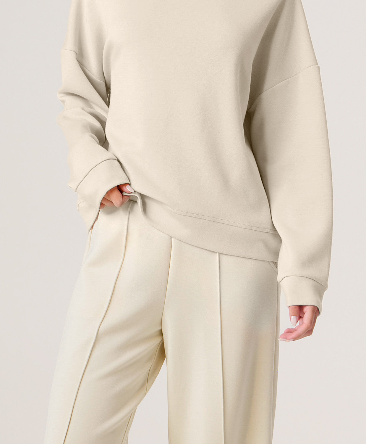 Woman wearing a beige set on a white background