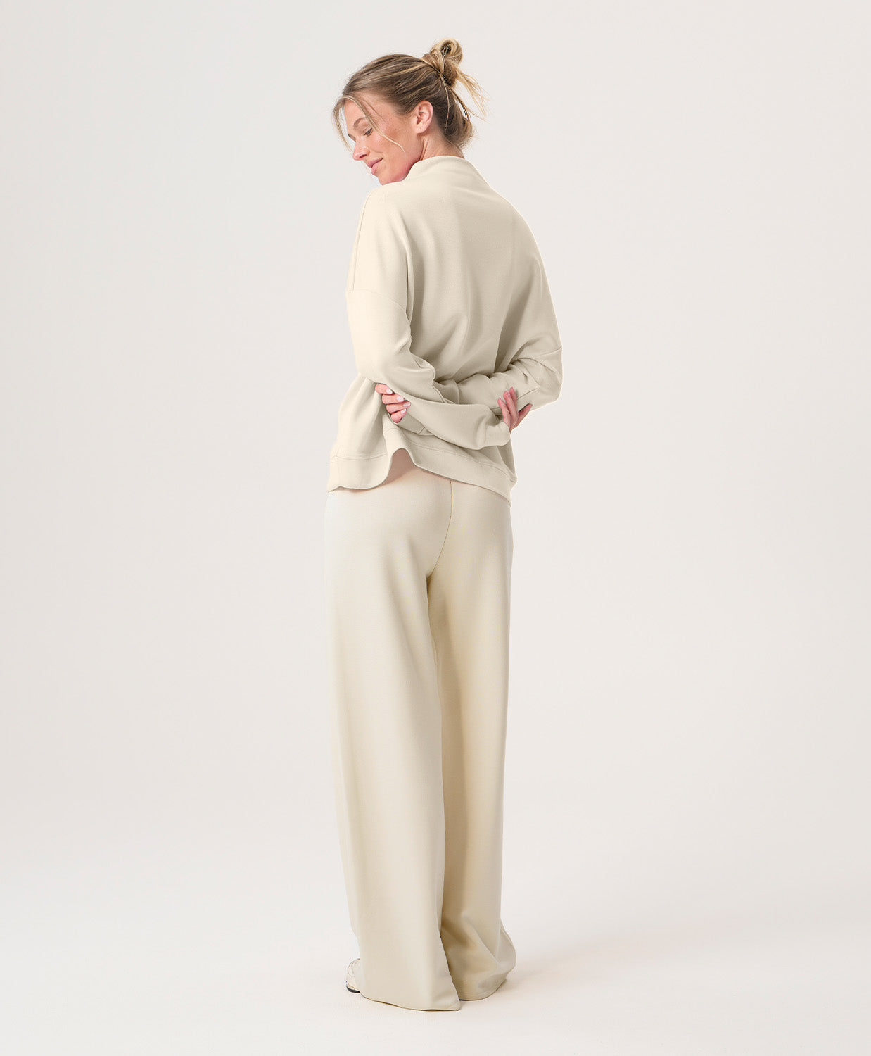 Woman wearing a beige outfit on a white background