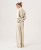 Woman wearing a beige outfit on a white background