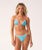Woman wearing a blue and pink bikini against a white background
