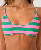 Close-up of a pink and green striped bikini top on a person.
