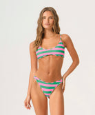 Woman wearing a striped bikini on a white background