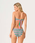 Woman wearing a green and pink striped swimsuit on a white background