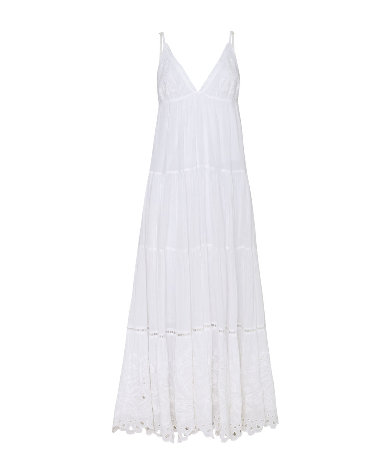 A long white dress with detailed embroidery against a white wall.