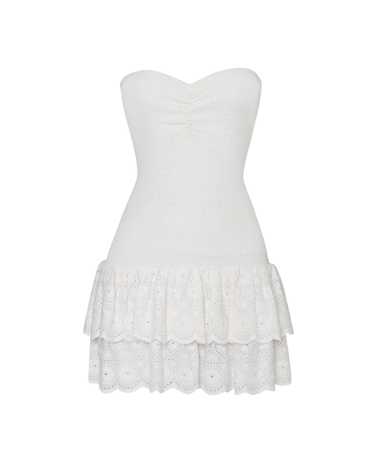 A white mini strapless dress with a ruffle bottom against a white wall.