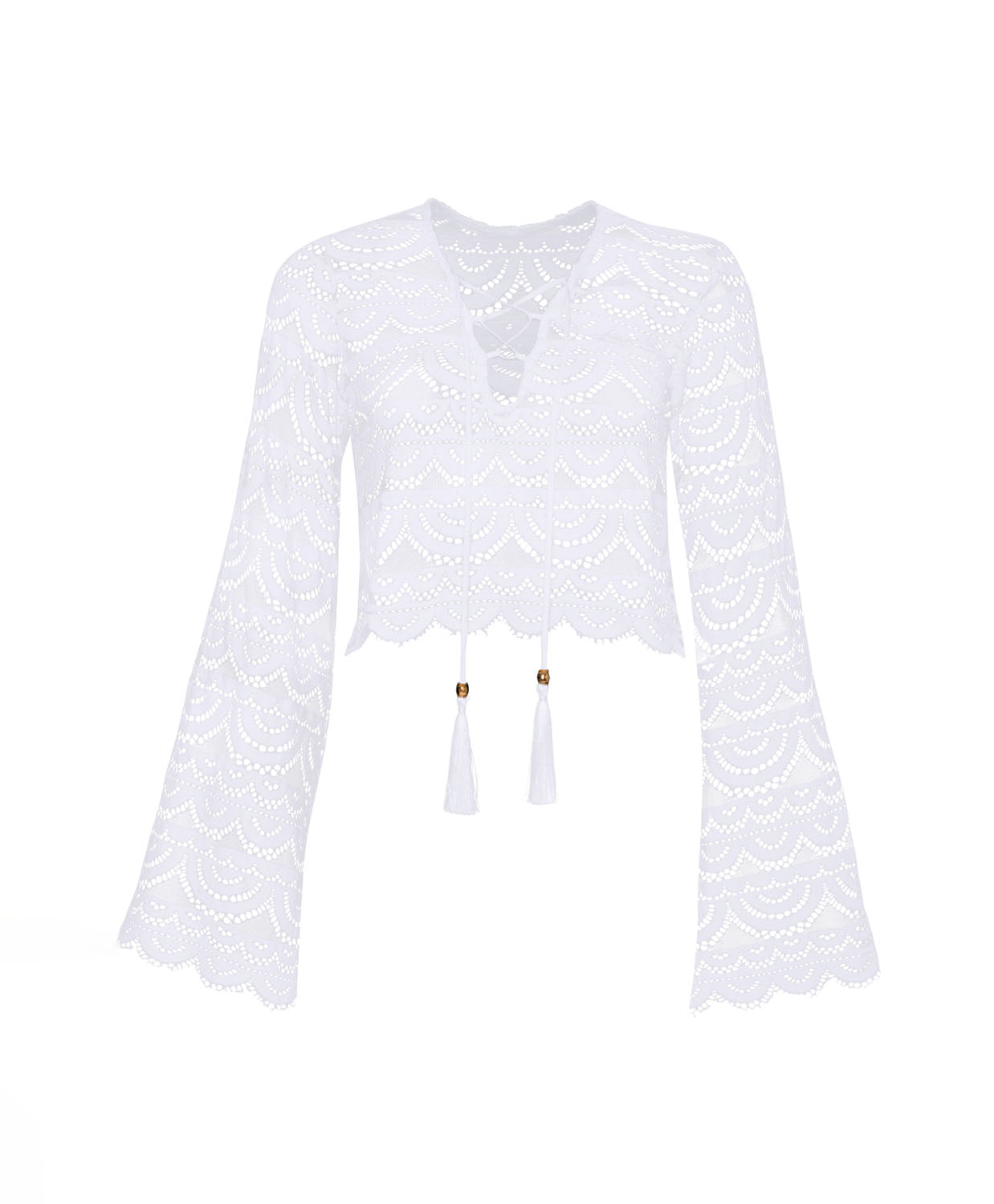 A long sleeve white lace top against a white wall.