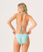 Woman wearing a light blue bikini on a white background