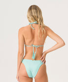 Person wearing a light blue bikini on a white background