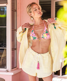 Yellow Stripe Gauze Short in sunny yellow and white pinstripes, featuring soft fabric and playful pink tassel ties, styled for casual summer wear or lounging.