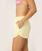 Yellow Stripe Gauze Short in sunny yellow and white pinstripes, featuring soft fabric and playful pink tassel ties, styled for casual summer wear or lounging.