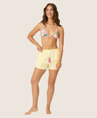 Yellow Stripe Gauze Short in sunny yellow and white pinstripes, featuring soft fabric and playful pink tassel ties, styled for casual summer wear or lounging.